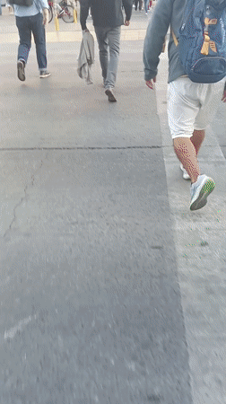 Pedestrians navigate busy Santiago streets on sunny afternoon