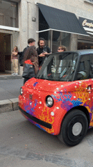 Electric cars, historic architecture observed in Milan streets