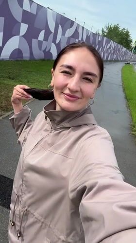 Woman films plane overhead in Sirius, Russia residential area