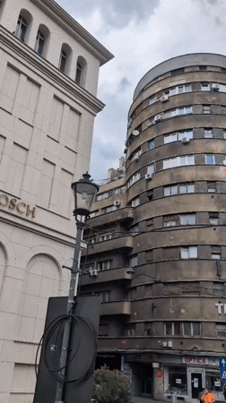 Bucharest streets mix brutalist blocks with ornate domed architecture