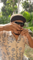 Street musician performs harmonica and jaw harp in Rawai