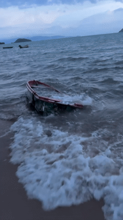 Storm-battered boat washed ashore off Ko Pha-ngan under heavy skies