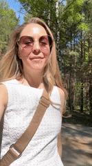 Woman films selfie, cyclist passes on forest road in Chaikovsky