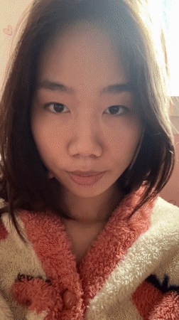 Woman in pink robe drinks juice, takes selfie in Chongqing