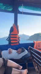 Man sleeps on boat bench in Vietnam