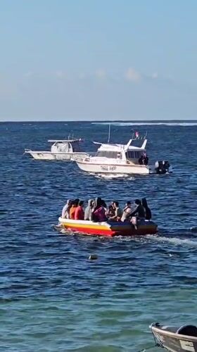Boats, beaches, and activity along Denpasar's busy coastline