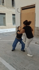 Woman performs acrobatic feat supporting man in Málaga