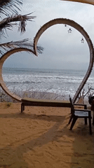Tourist documents morning scenes at Ashvem Beach, Goa