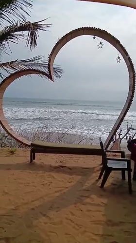 Tourist documents morning scenes at Ashvem Beach, Goa