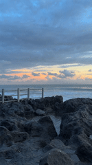 Sunset coastal activity documented along Mengwi Indonesia rocky shoreline