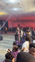 Packed venue in Ikeja lights up under red and stage lighting
