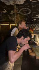 Young men share drinks at Lyon bar Thursday evening