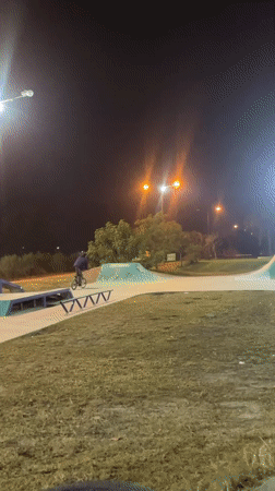 Night cyclist performs tricks at Argentine skate park