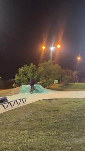 Night cyclist performs tricks at Argentine skate park