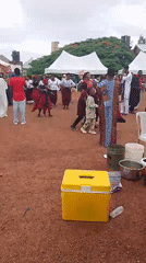 Women perform traditional dances at outdoor community gathering