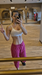 Woman Takes Workout Selfie in Studio Mirror
