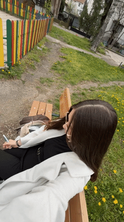 Woman sits contemplatively on park bench in Sofia