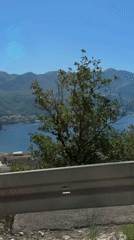 Traveler records scenic coastal views while driving through Montenegro