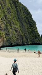 Ao Nang beach scene with crowds, cliffs, and a swim warning