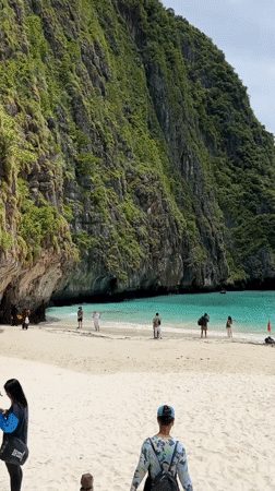 Ao Nang beach scene with crowds, cliffs, and a swim warning