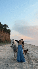 Beach scene with woman, white horse captured in Pavlo-Ochakovo