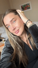 Woman poses for casual selfies in Moscow hotel room
