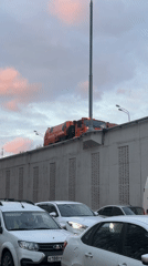 Orange tanker truck passes over Moscow traffic jam