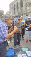 Man addresses group near historic Plaza San Martín in Lima