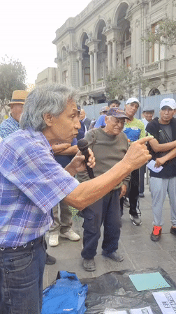 Man addresses group near historic Plaza San Martín in Lima