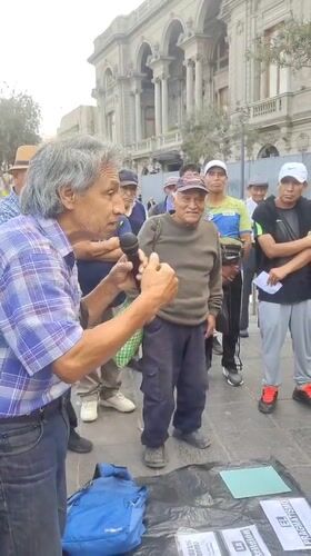 Man addresses group near historic Plaza San Martín in Lima