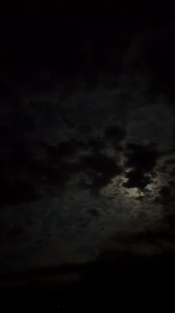 Dramatic cloudy skies obscure moon over Lovech, Bulgaria
