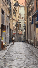Early morning scene captured on narrow Genoa cobblestone street
