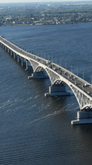 Aerial view of Saratov's arched river bridge with active traffic