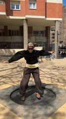 Woman enjoys public trampoline in Barcelona outdoor space