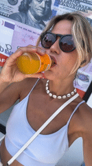 Woman drinks from bottle in North Kuta, Indonesia