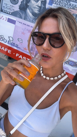 Woman drinks from bottle in North Kuta, Indonesia
