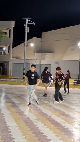 Night dancing gathering observed near Tacna's iconic arch