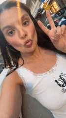 Woman takes playful selfies near cars in Tel Aviv