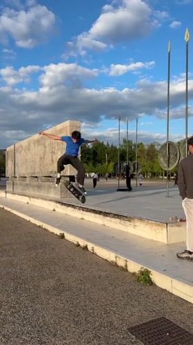 Skateboarder attempts tricks at Thessaloniki plaza, stumbles during maneuver