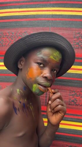 Face painting session with vibrant colors in Ado