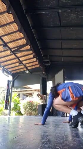 Cheerleader performs acrobatics at tropical resort venue in Venezuela