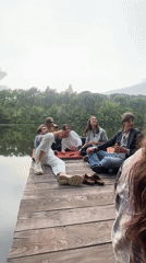 Group gathers at lakeside dock in Lucignano, Italy