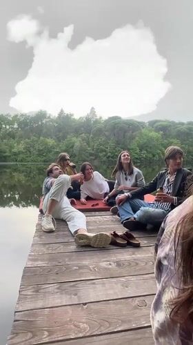 Group gathers at lakeside dock in Lucignano, Italy