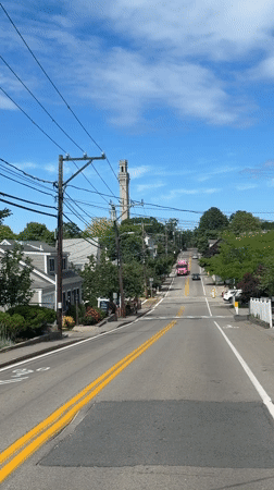 Pink bus rolls up toward Provincetown's Pilgrim Monument