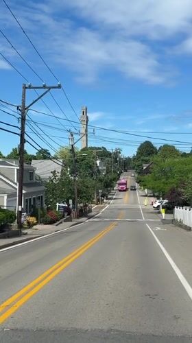 Pink bus rolls up toward Provincetown's Pilgrim Monument