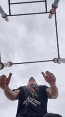 Person exercises at outdoor calisthenics park during midday visit