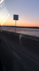 Sunrise over water captured from vehicle near Chaikovsky, Russia