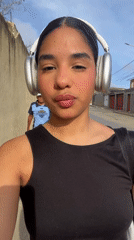 Woman in headphones spotted outdoors on sunny day
