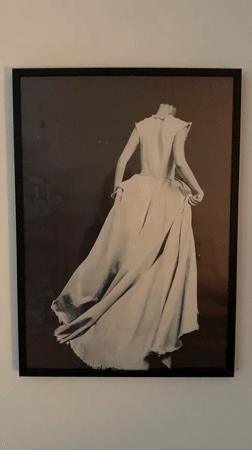 Person works in home studio, touches framed photo in Rusanovo