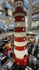 Bangkok mall features lighthouse decoration among clothing displays